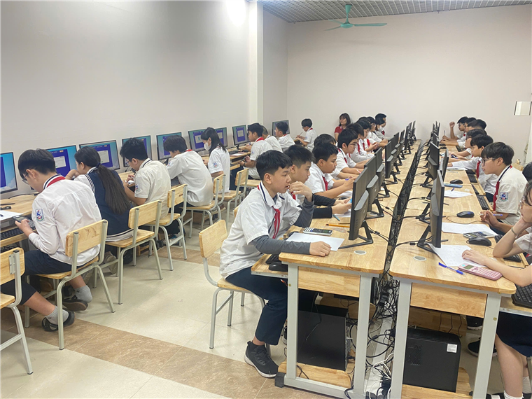 A group of people sitting at desks in a room with computers

AI-generated content may be incorrect.