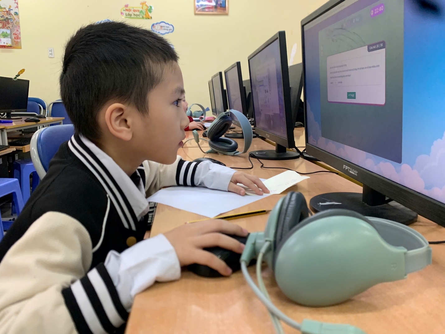 A child sitting at a desk with a computer

AI-generated content may be incorrect.