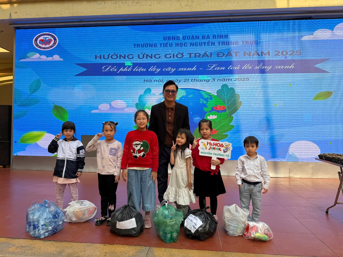 A group of children standing in front of a large screen

AI-generated content may be incorrect.