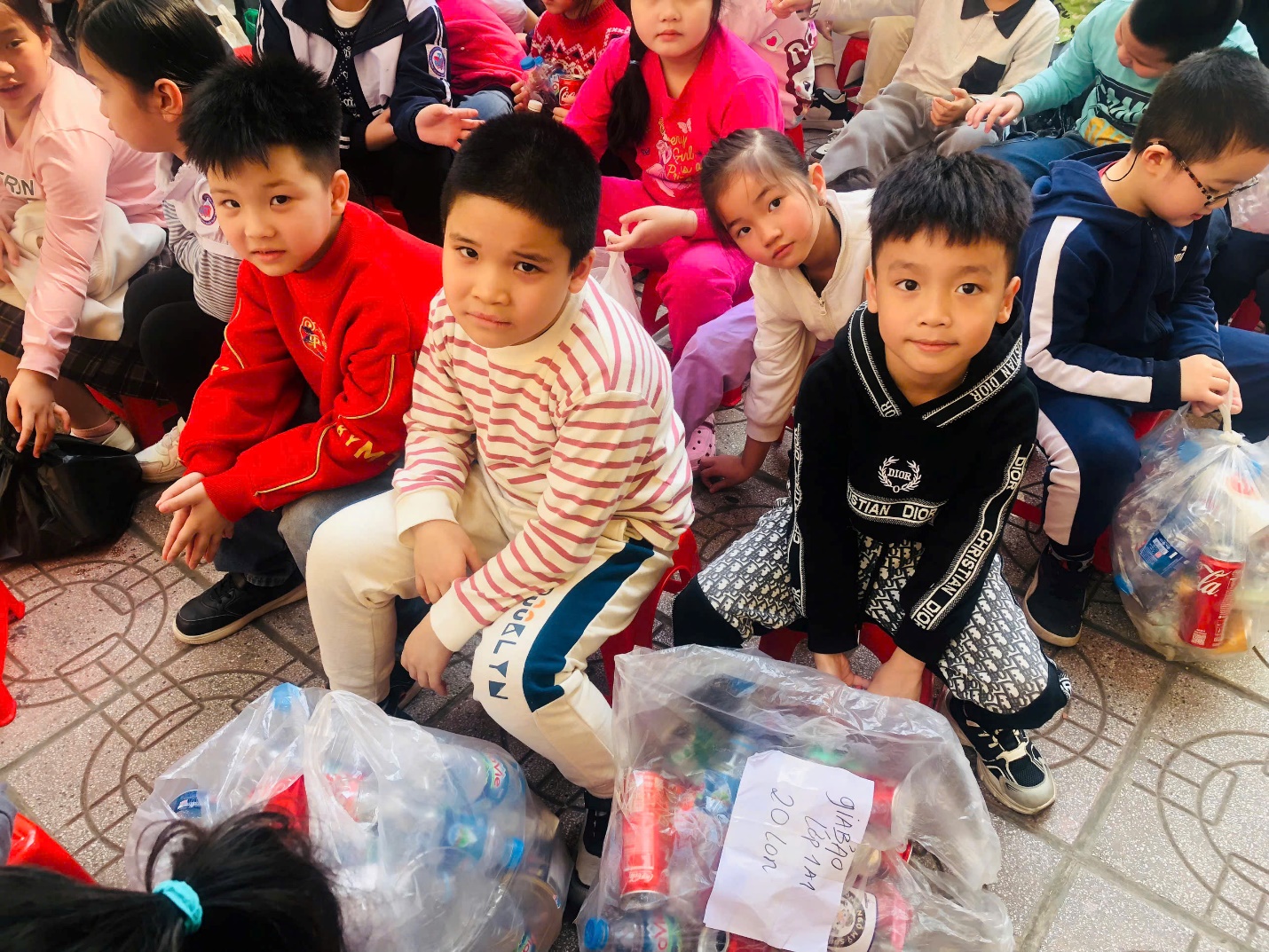 A group of children sitting on the ground

AI-generated content may be incorrect.