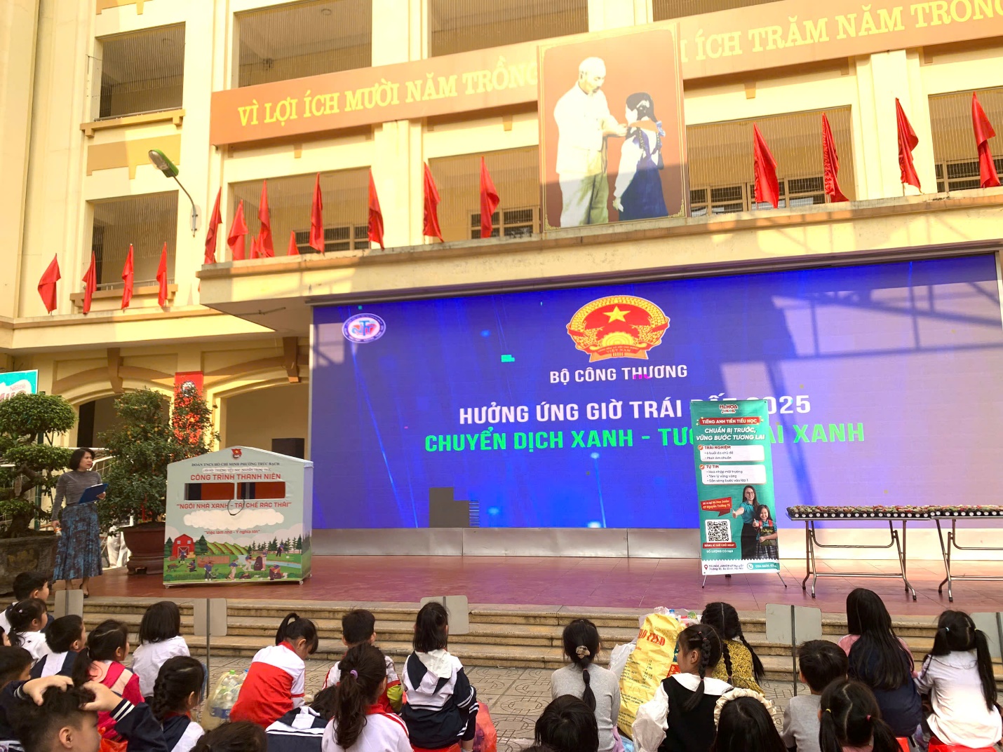 A group of people sitting on steps in front of a large screen

AI-generated content may be incorrect.
