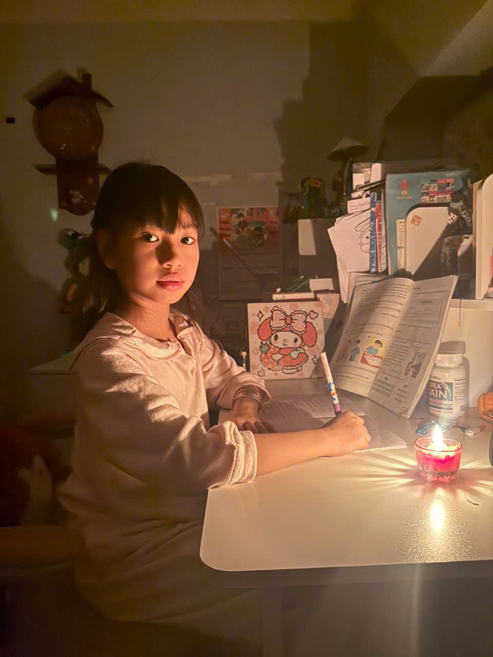 A child sitting at a table writing on a book

AI-generated content may be incorrect.