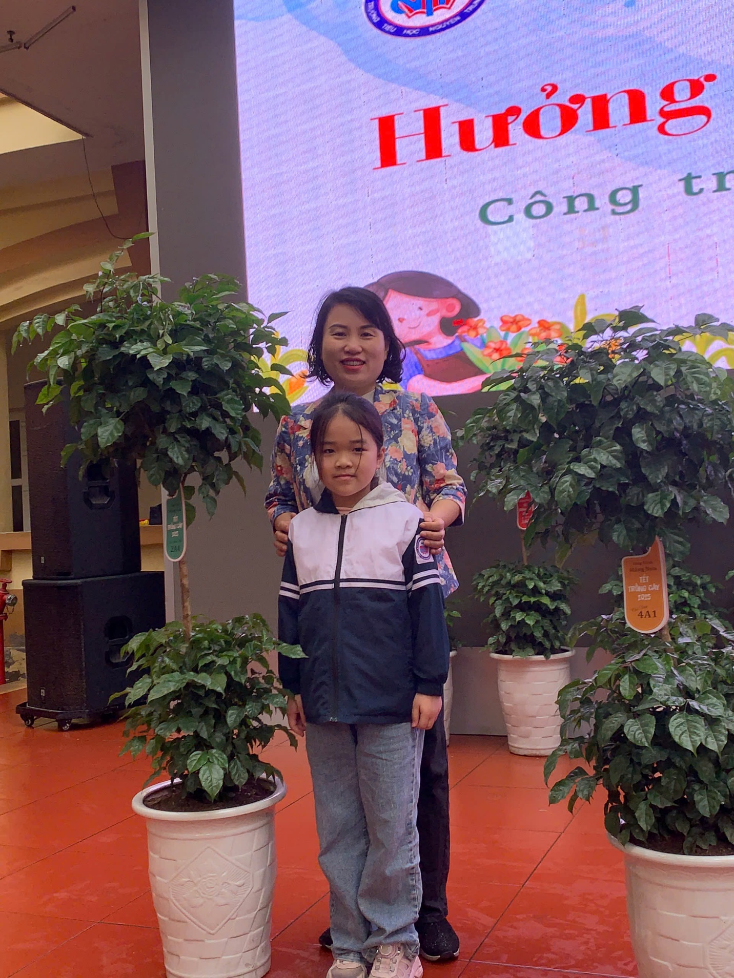 A person and child standing in front of plants
AI-generated content may be incorrect.