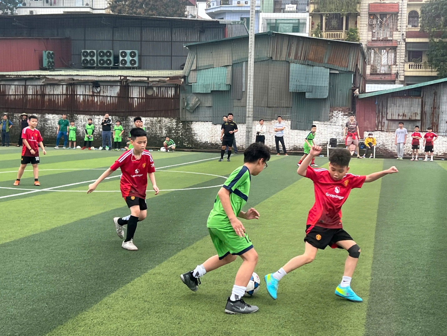 A group of kids playing football on a field

AI-generated content may be incorrect.