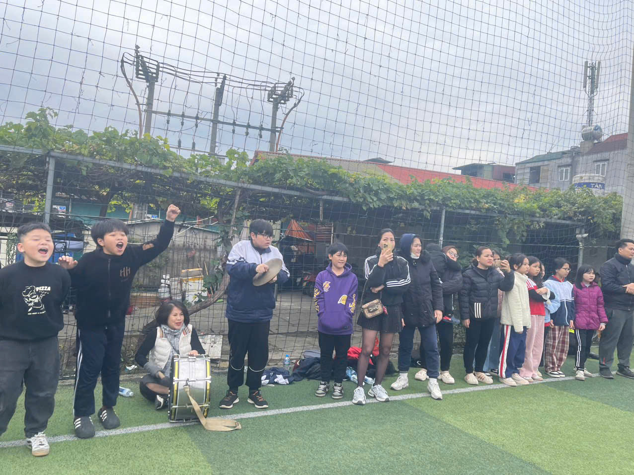 A group of people standing on a field

AI-generated content may be incorrect.