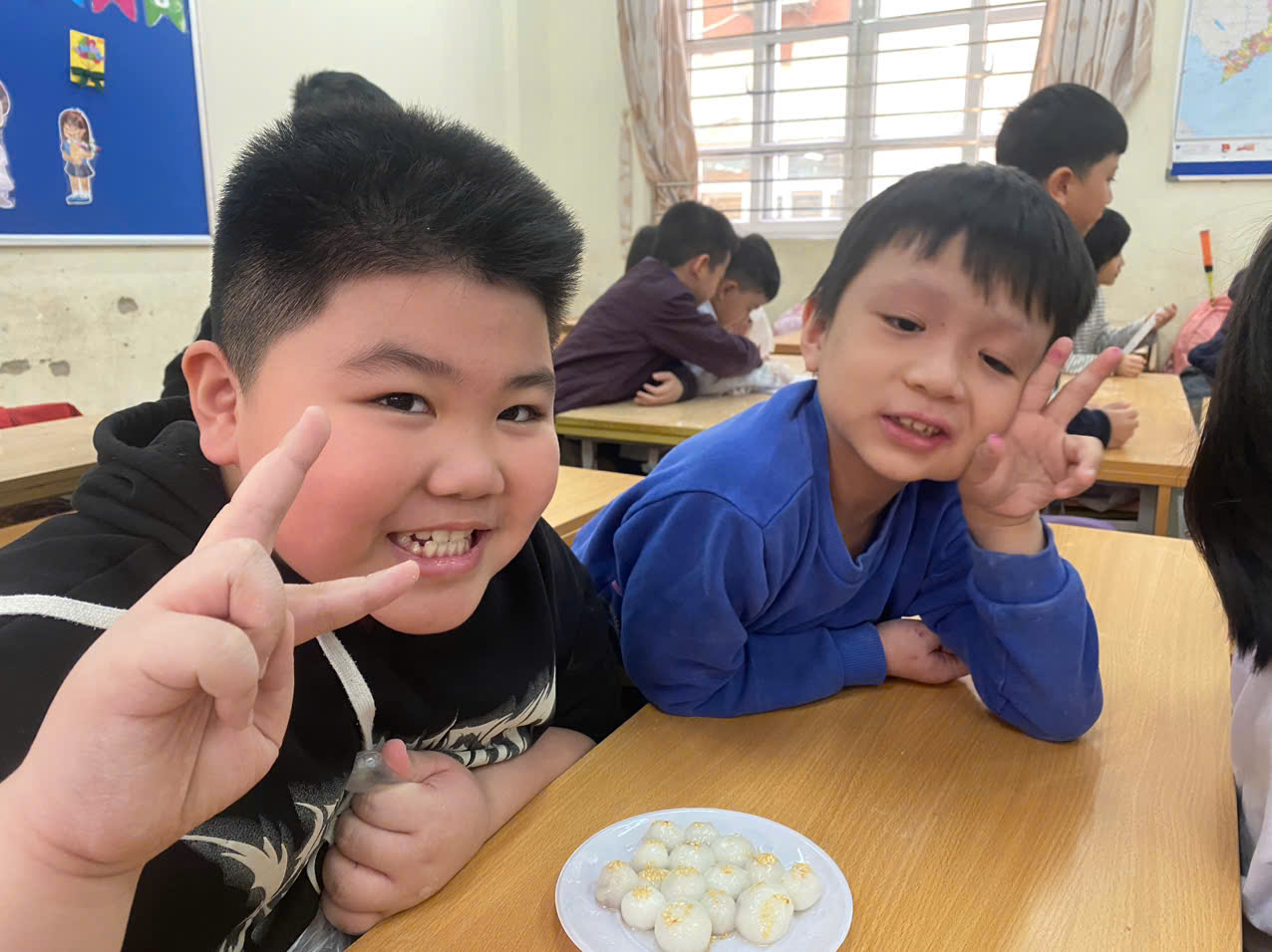 A group of boys sitting at a table with food
AI-generated content may be incorrect.