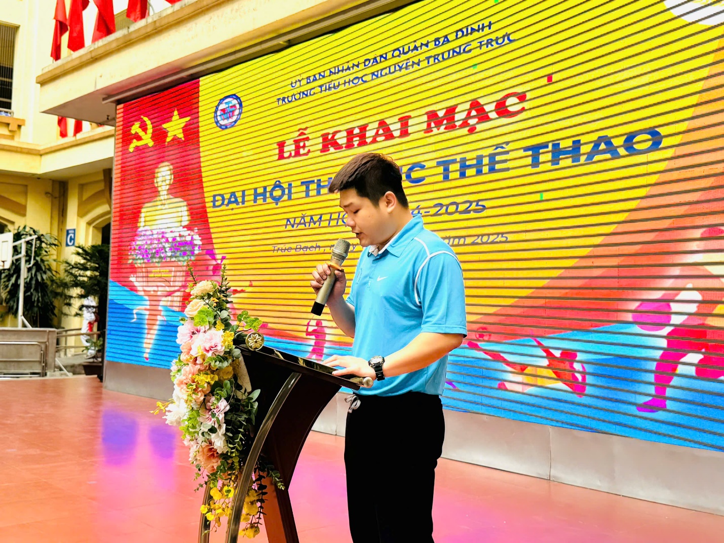 A person standing at a podium with a microphone

AI-generated content may be incorrect.