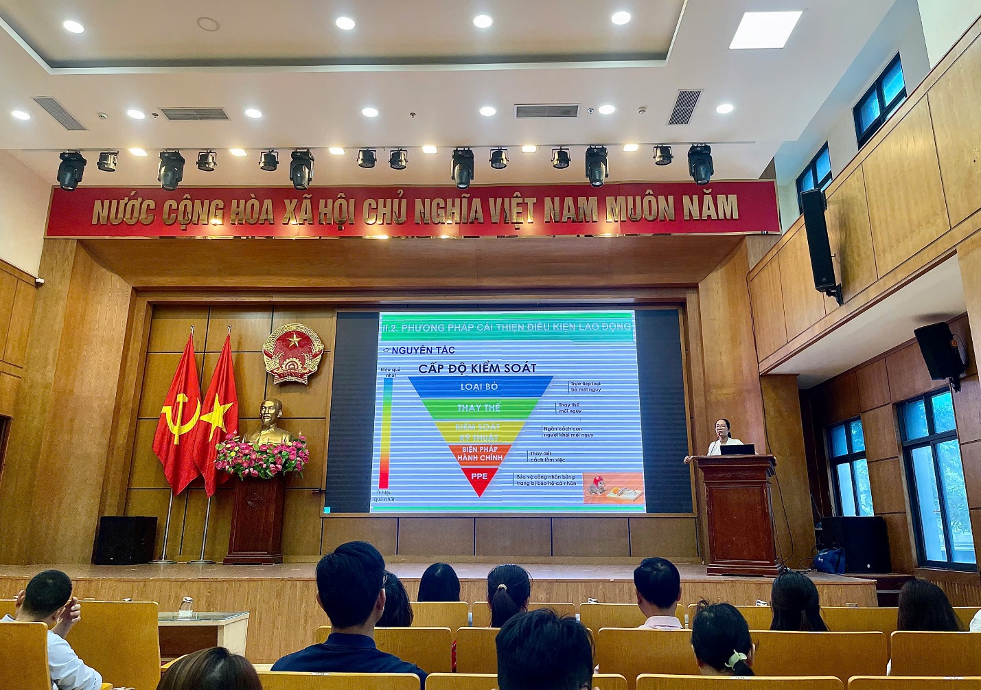 A group of people sitting in chairs in front of a screen
AI-generated content may be incorrect.