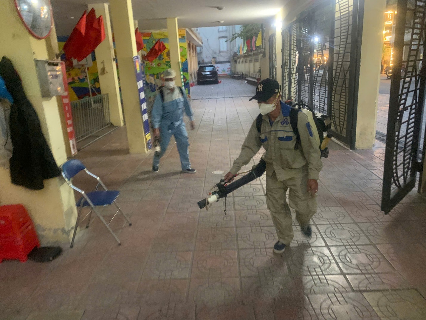 A person wearing a mask and holding a fogger
AI-generated content may be incorrect.