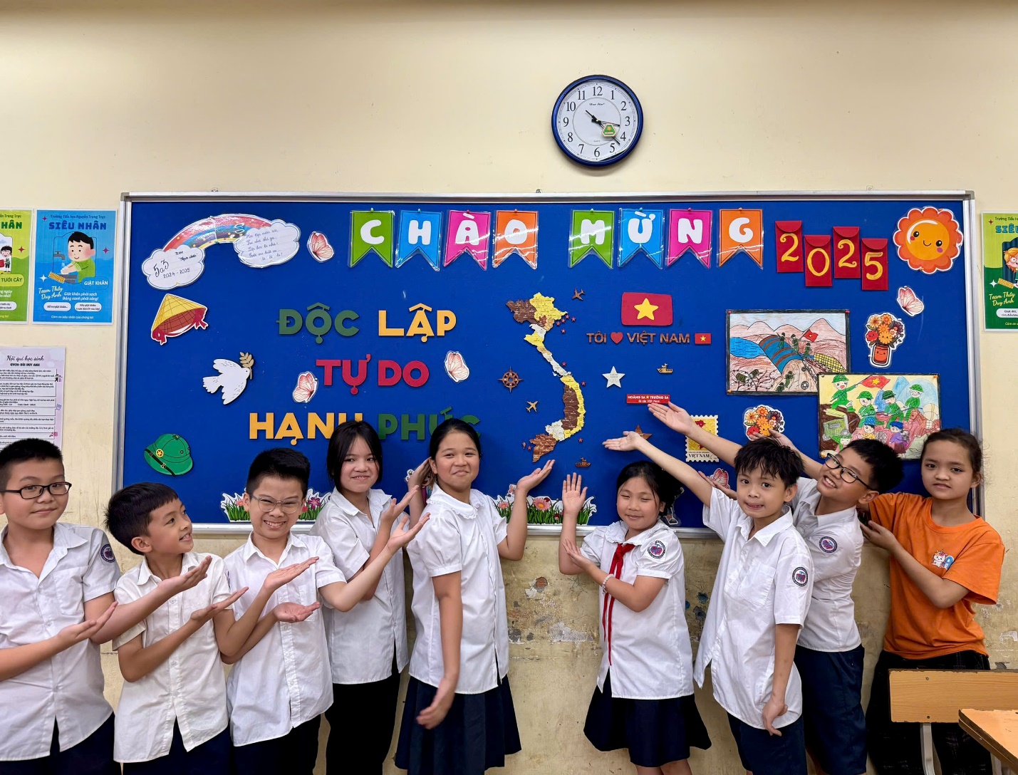 A group of children in uniform standing in front of a board

AI-generated content may be incorrect.