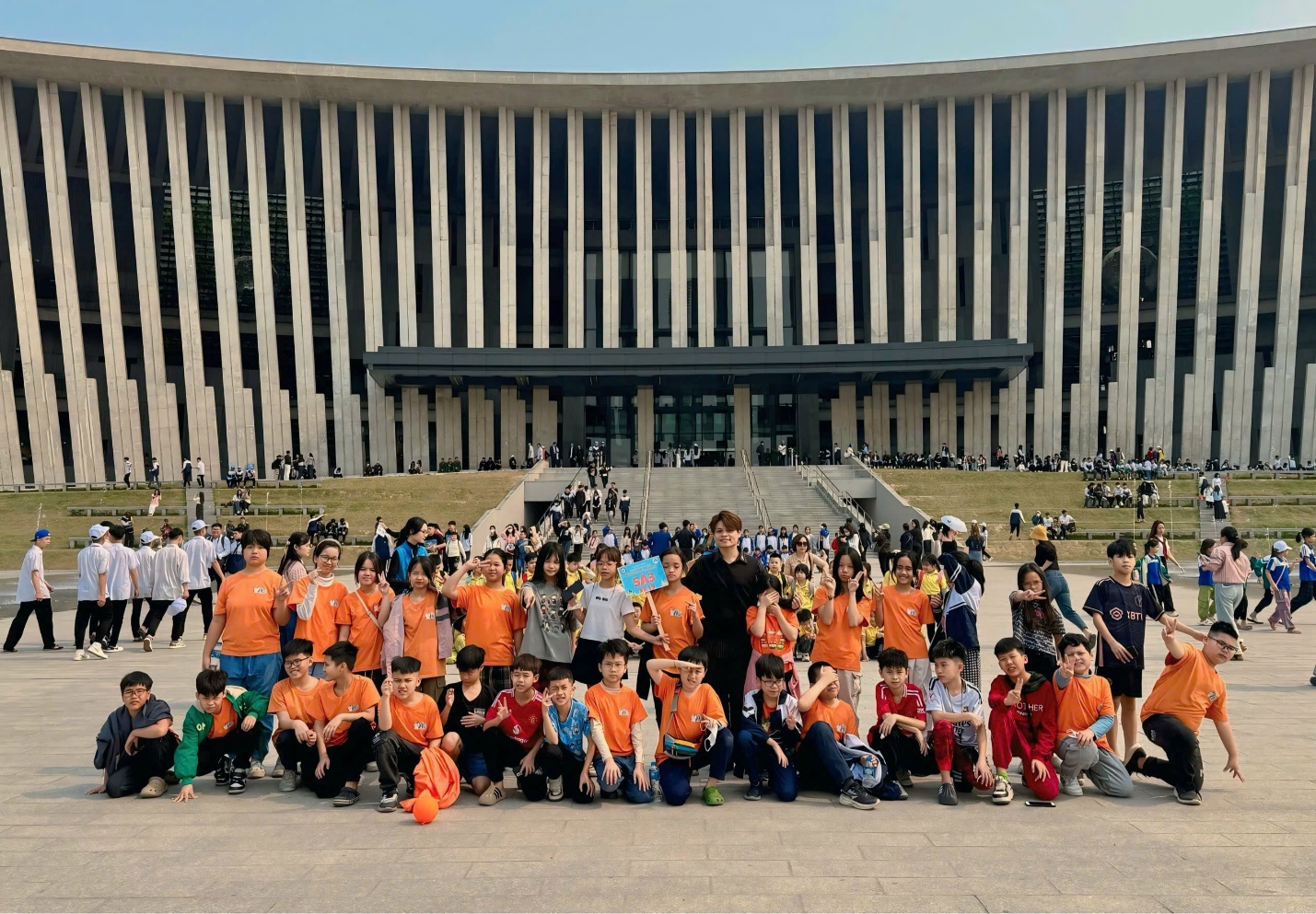 A group of people posing for a photo in front of a building
AI-generated content may be incorrect.