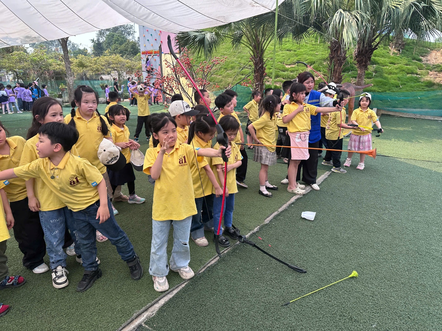 A group of children in yellow shirts
AI-generated content may be incorrect.