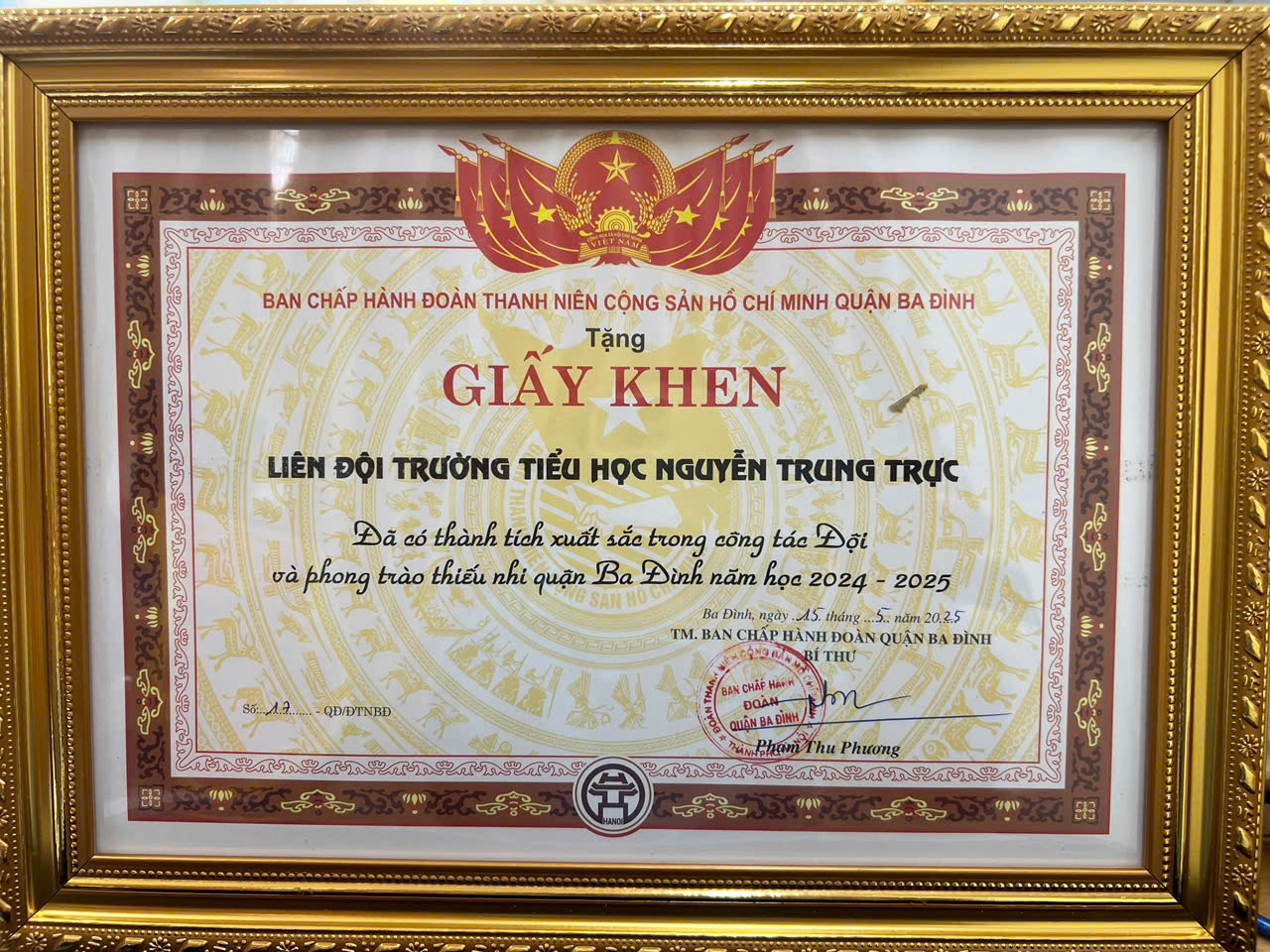 A gold framed certificate with red and gold text
AI-generated content may be incorrect.