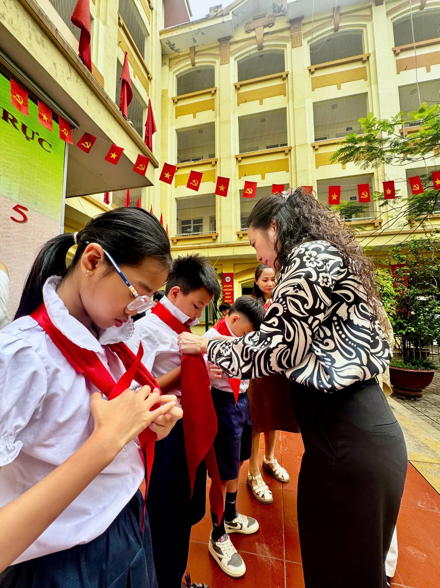 A person tying a red tie on a school uniform

AI-generated content may be incorrect.