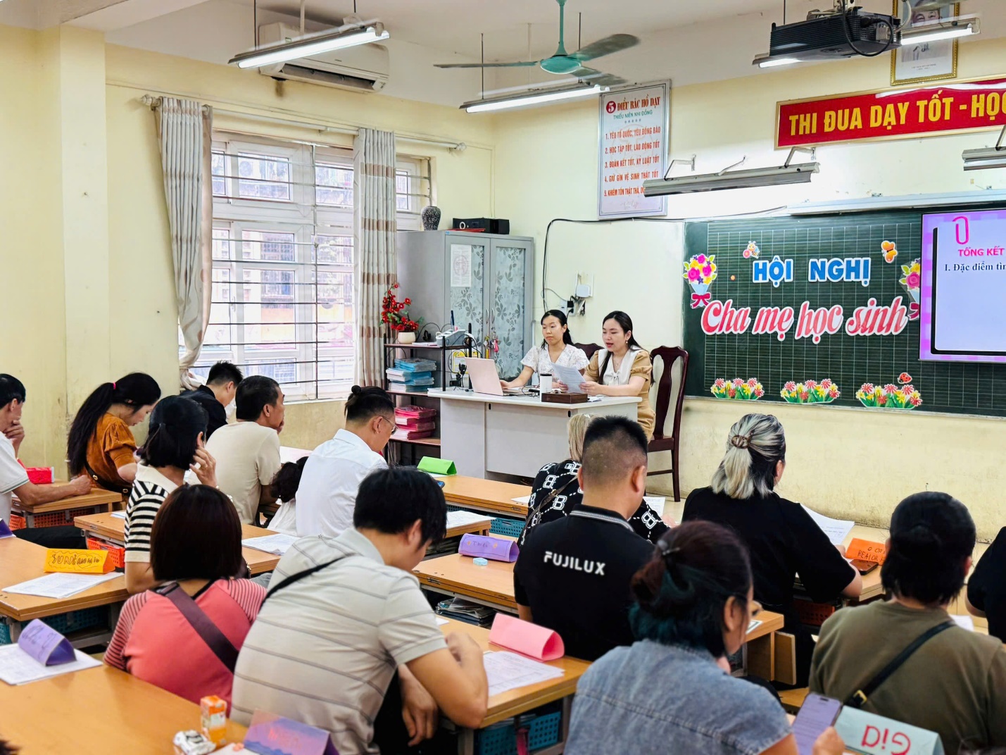 A group of people sitting at desks in a classroom

AI-generated content may be incorrect.