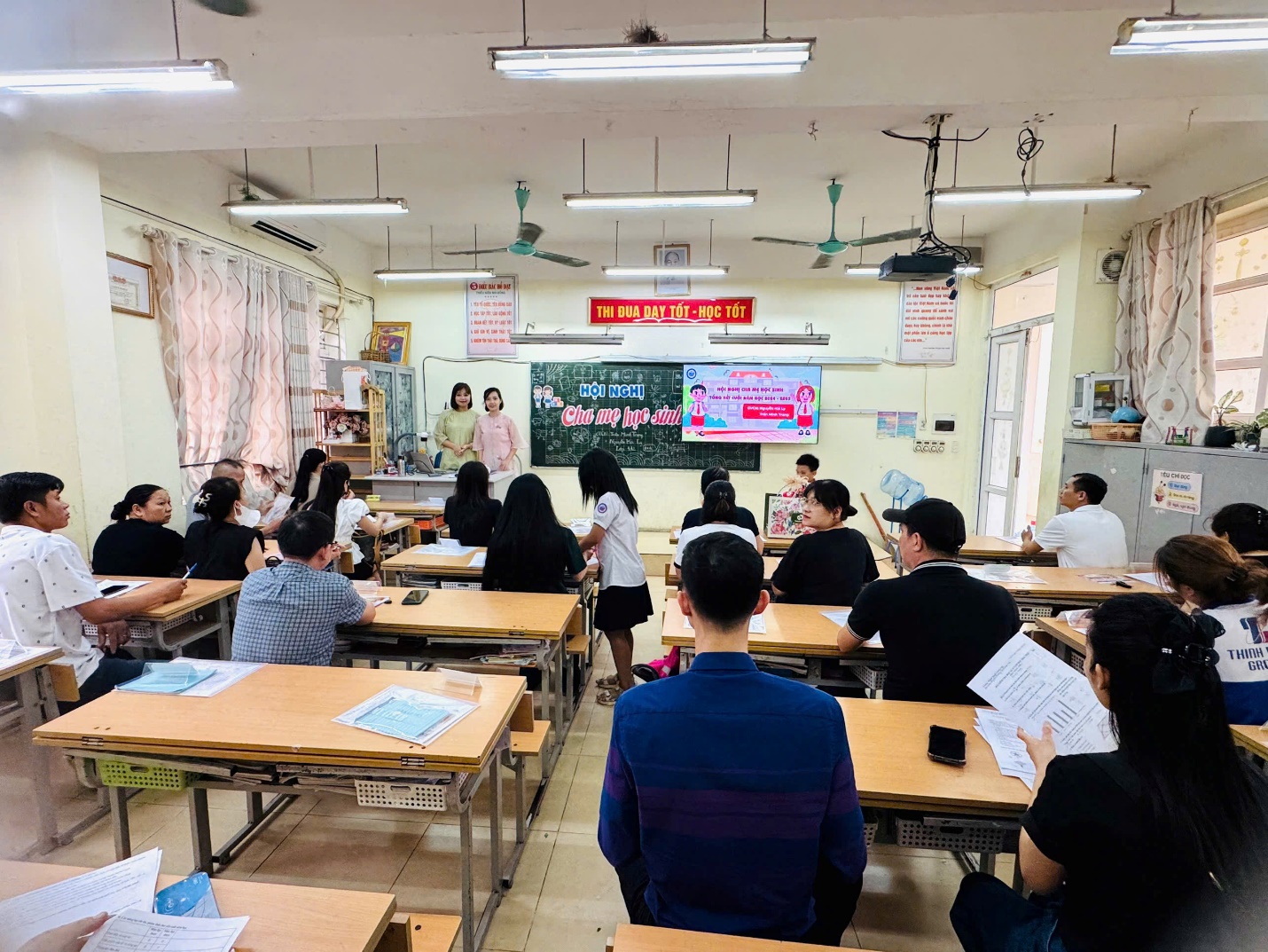 A group of people sitting at desks in a classroom

AI-generated content may be incorrect.