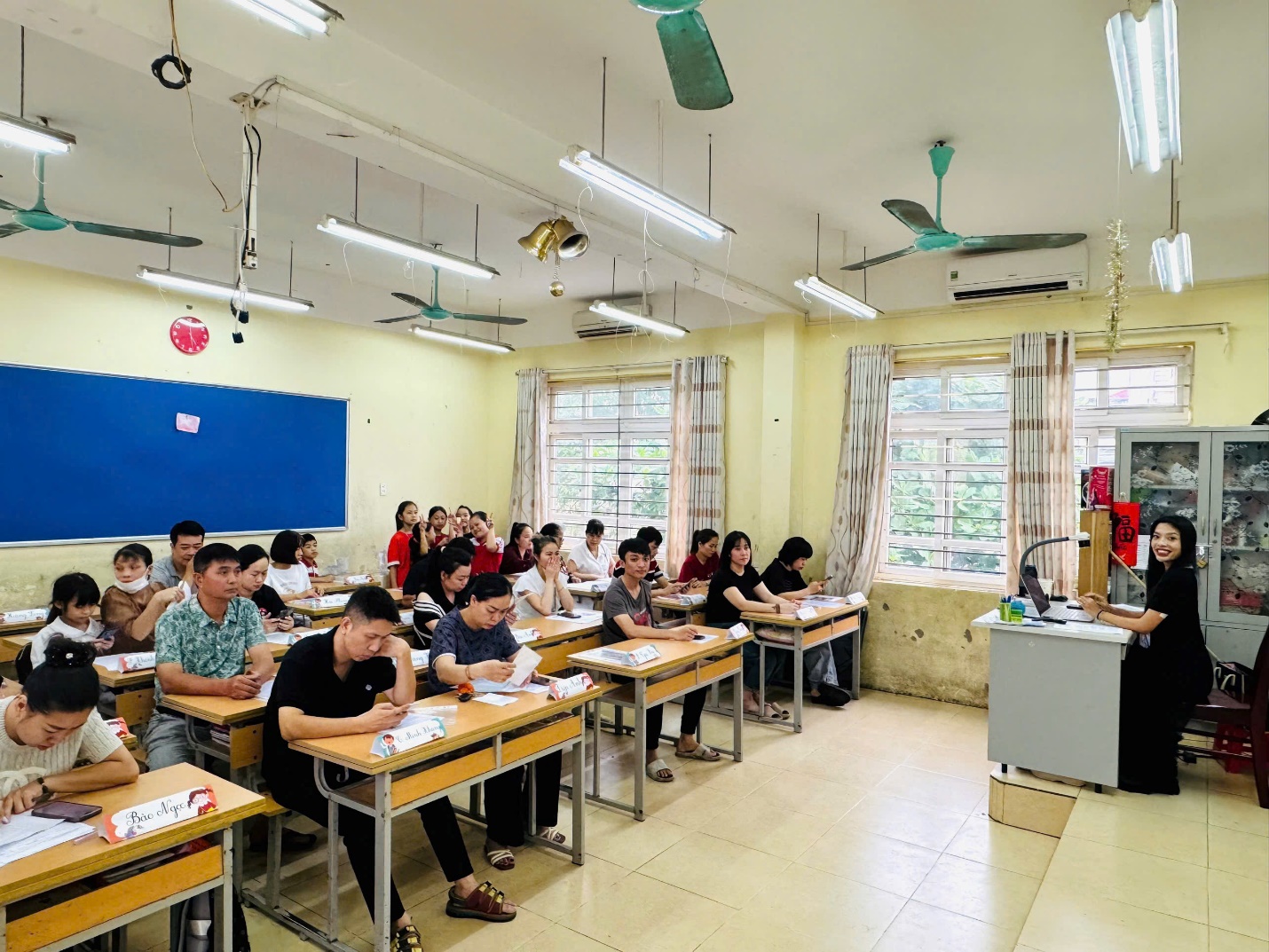 A group of people sitting at desks in a classroom

AI-generated content may be incorrect.