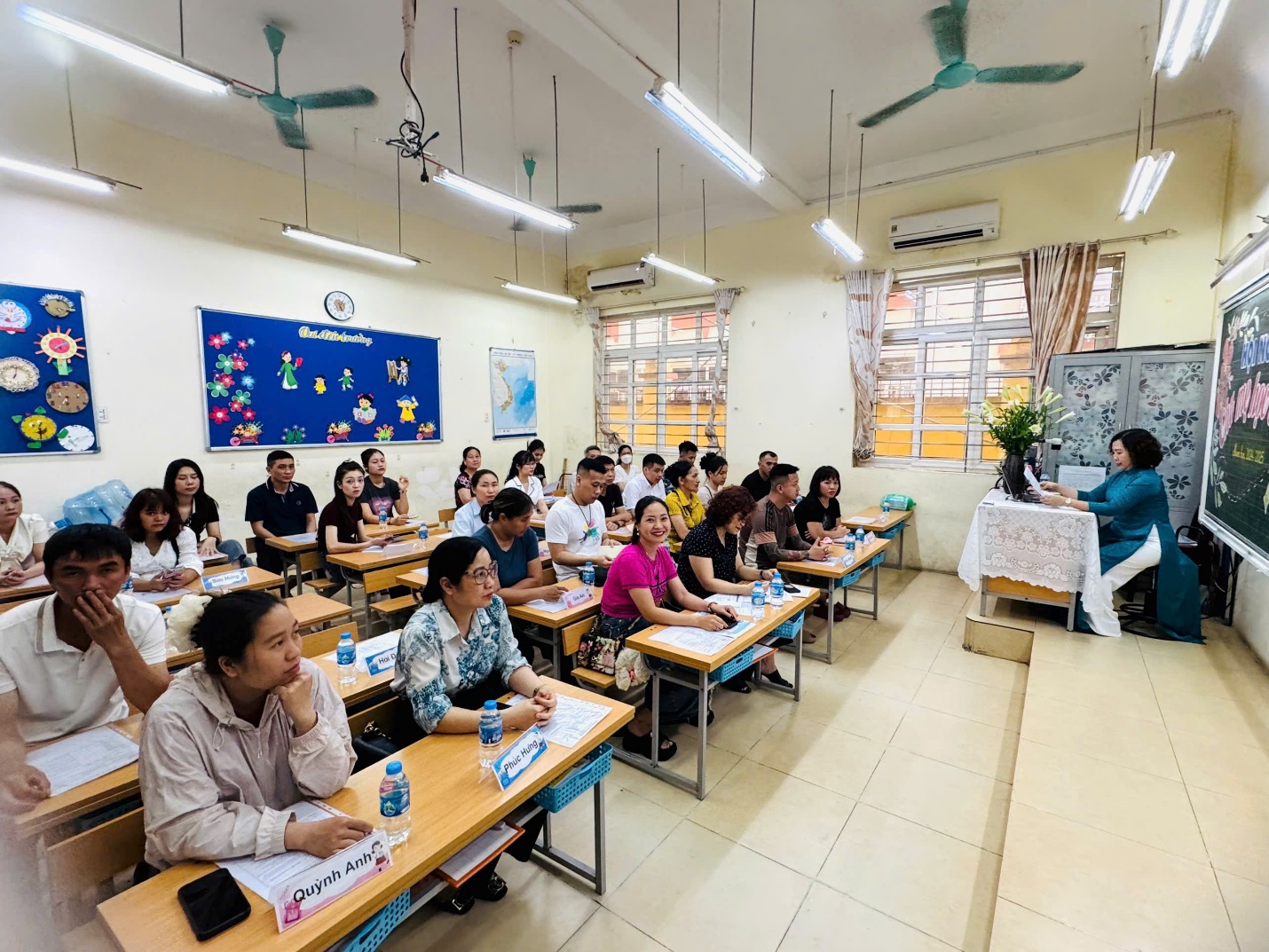 A group of people sitting at desks in a classroom

AI-generated content may be incorrect.