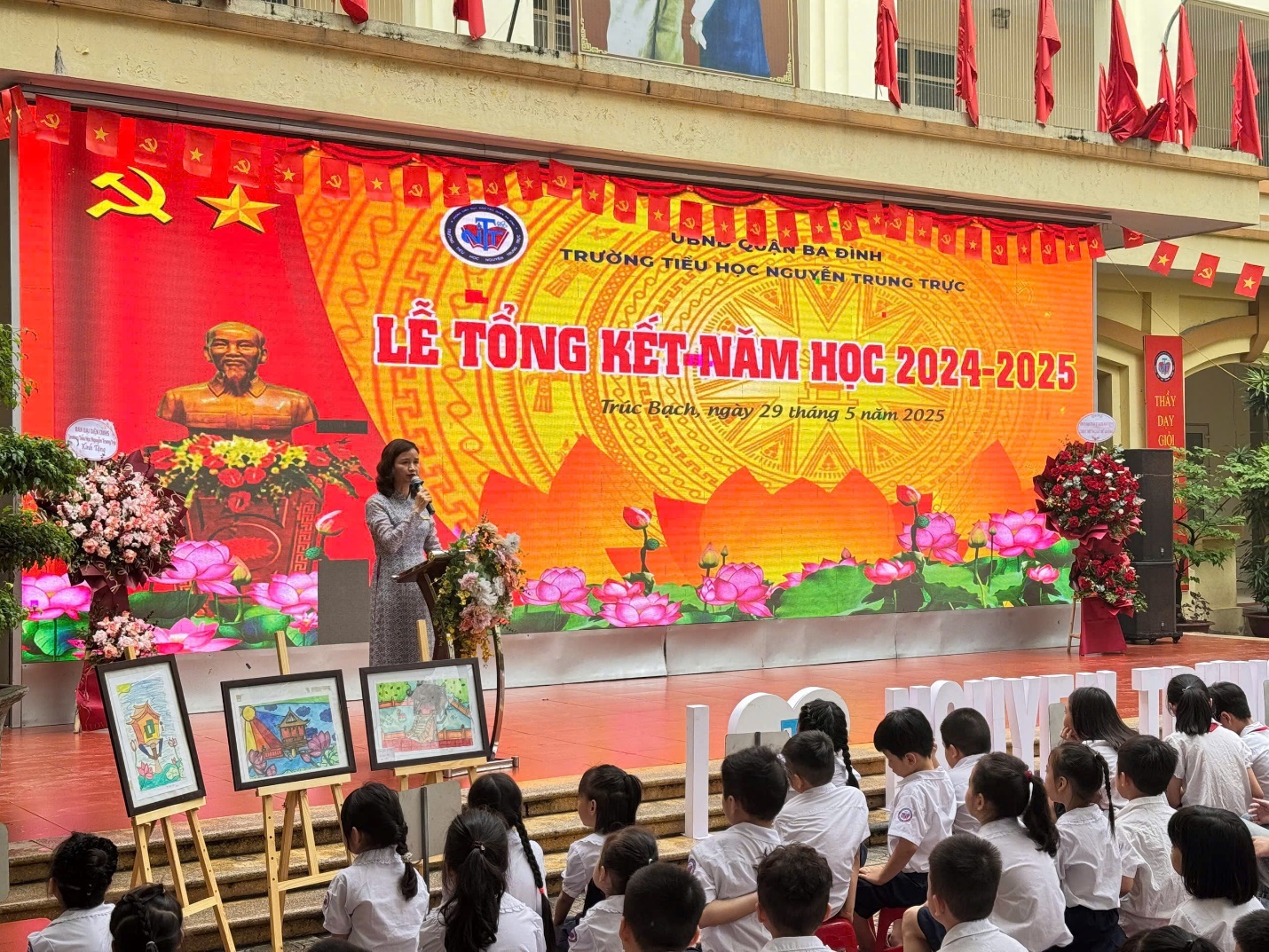 A person standing on a stage with a group of children

AI-generated content may be incorrect.