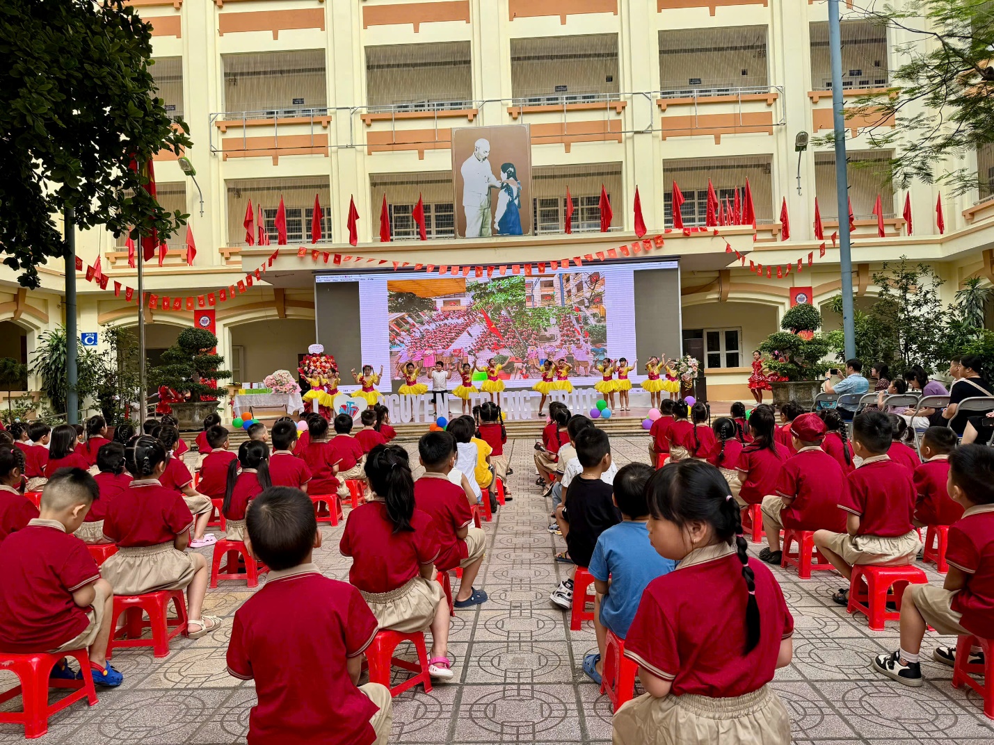 A group of children sitting on chairs in front of a building

AI-generated content may be incorrect.