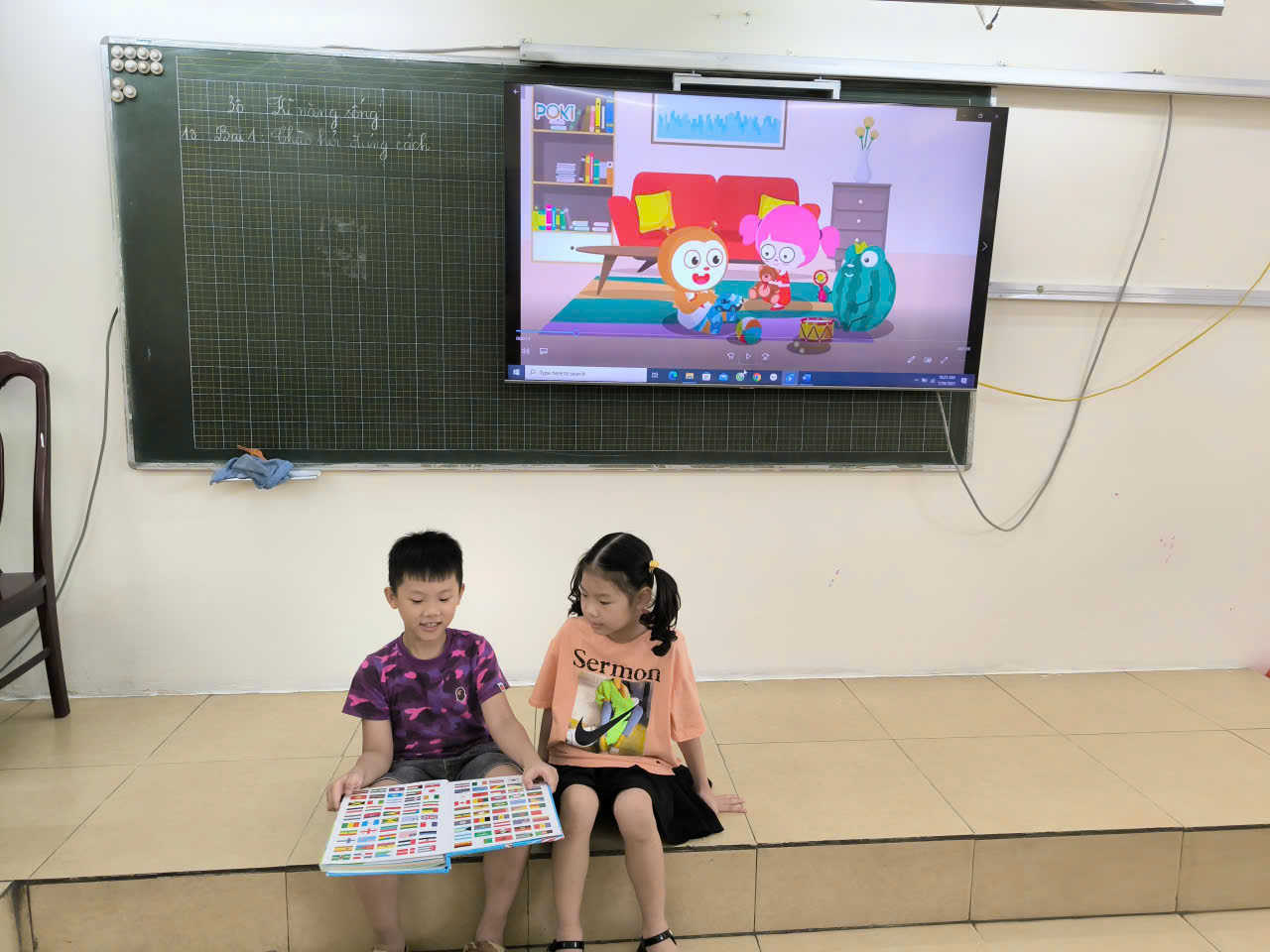 A child and child sitting on the floor reading a book
AI-generated content may be incorrect.