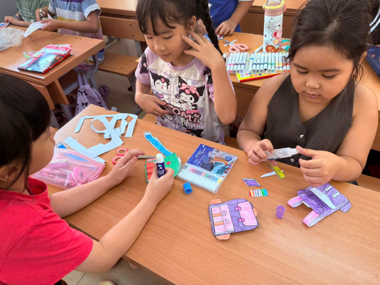 A group of children making crafts
AI-generated content may be incorrect.