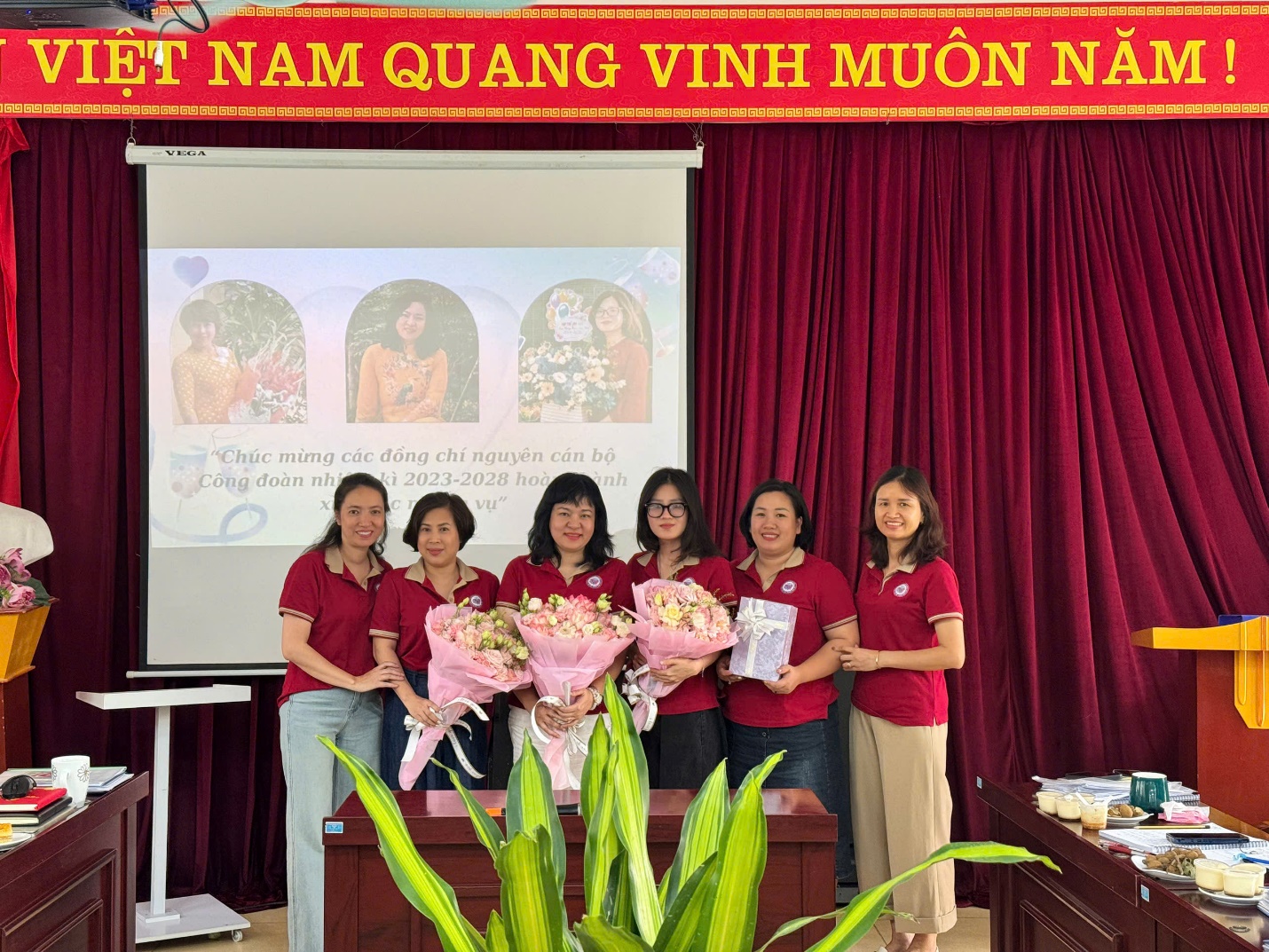 A group of women standing in front of a projector screen
AI-generated content may be incorrect.