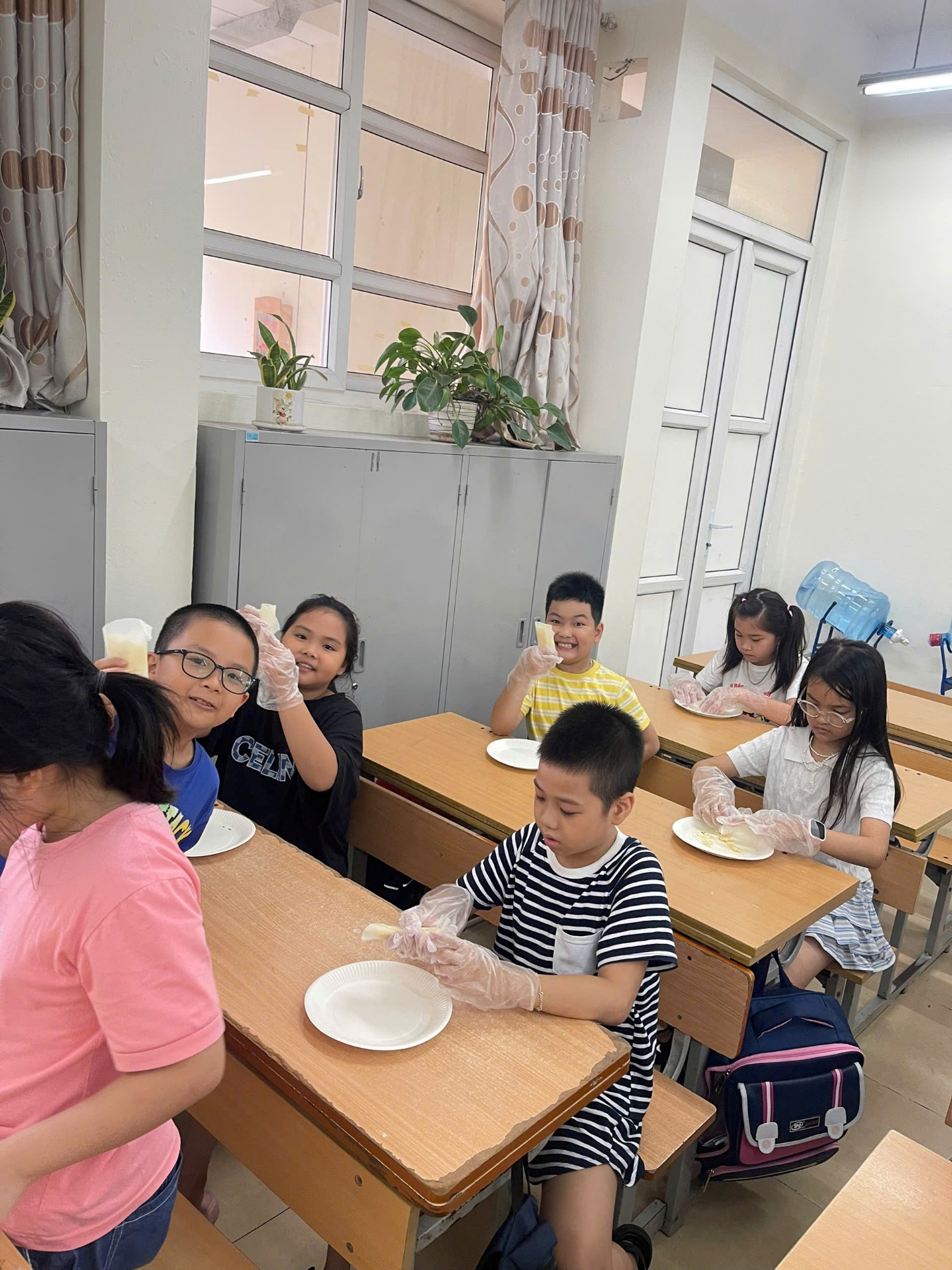 A group of children sitting at desks in a classroom

AI-generated content may be incorrect.