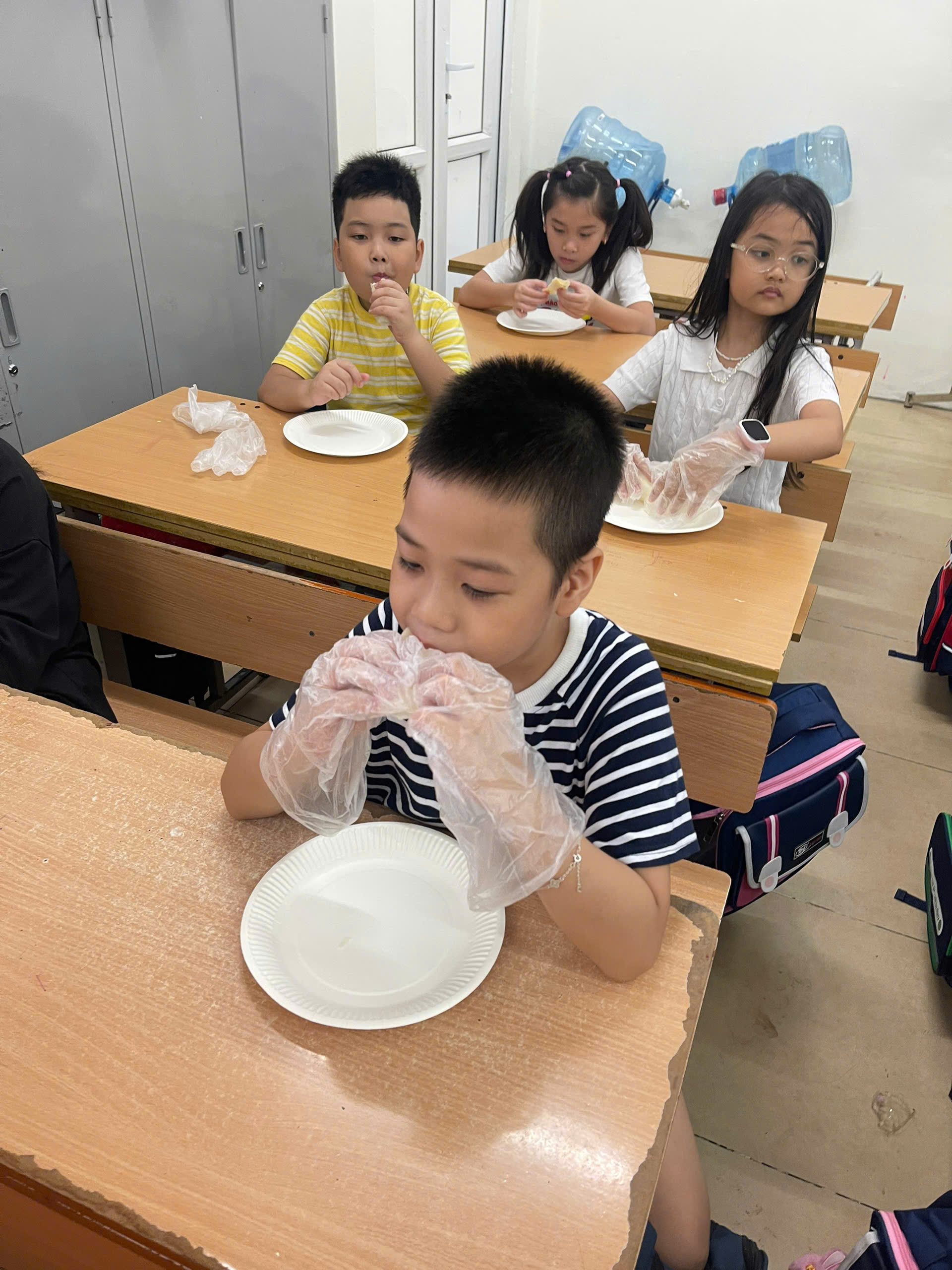 A group of children sitting at desks in a classroom

AI-generated content may be incorrect.