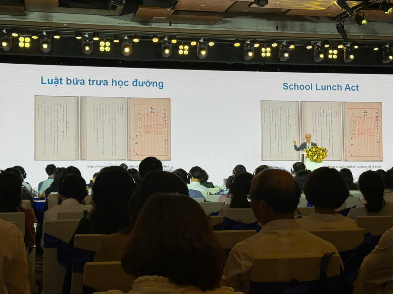 A group of people sitting in chairs in front of a large screen

AI-generated content may be incorrect.