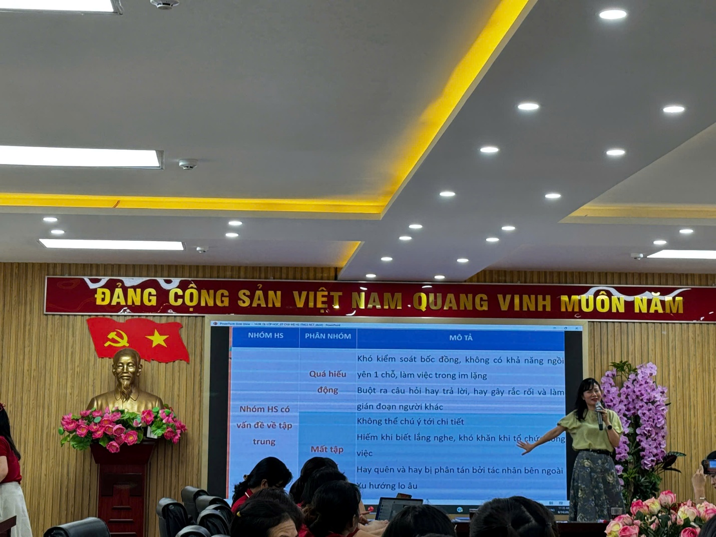 A person standing in front of a screen with a large screen with a person standing in front of it

AI-generated content may be incorrect.