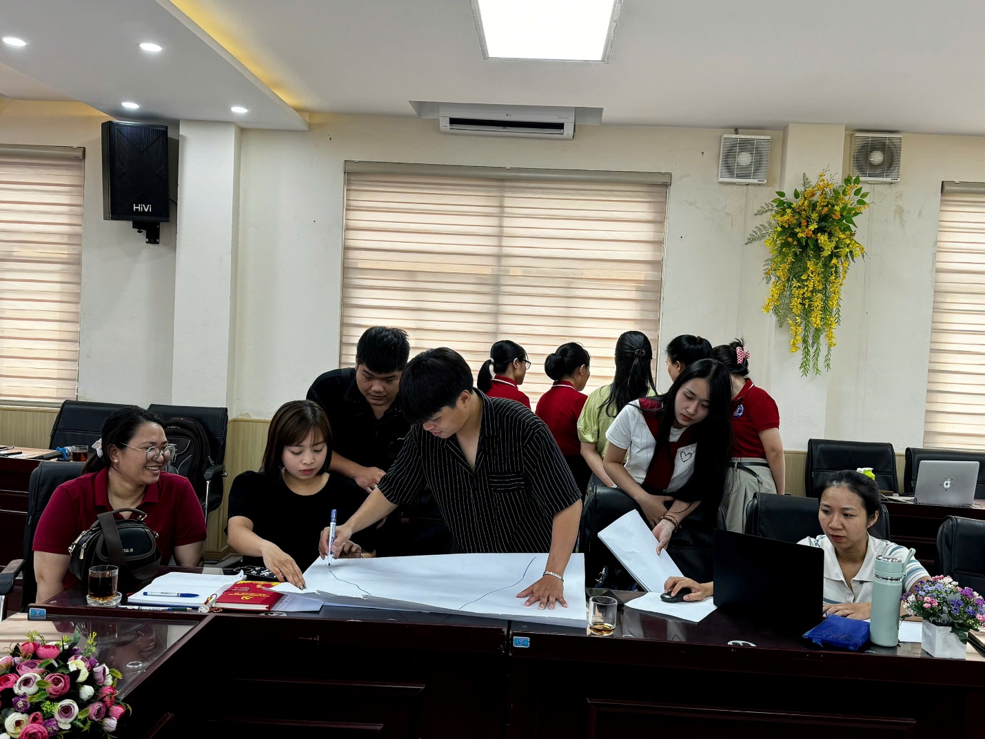 A group of people around a table

AI-generated content may be incorrect.