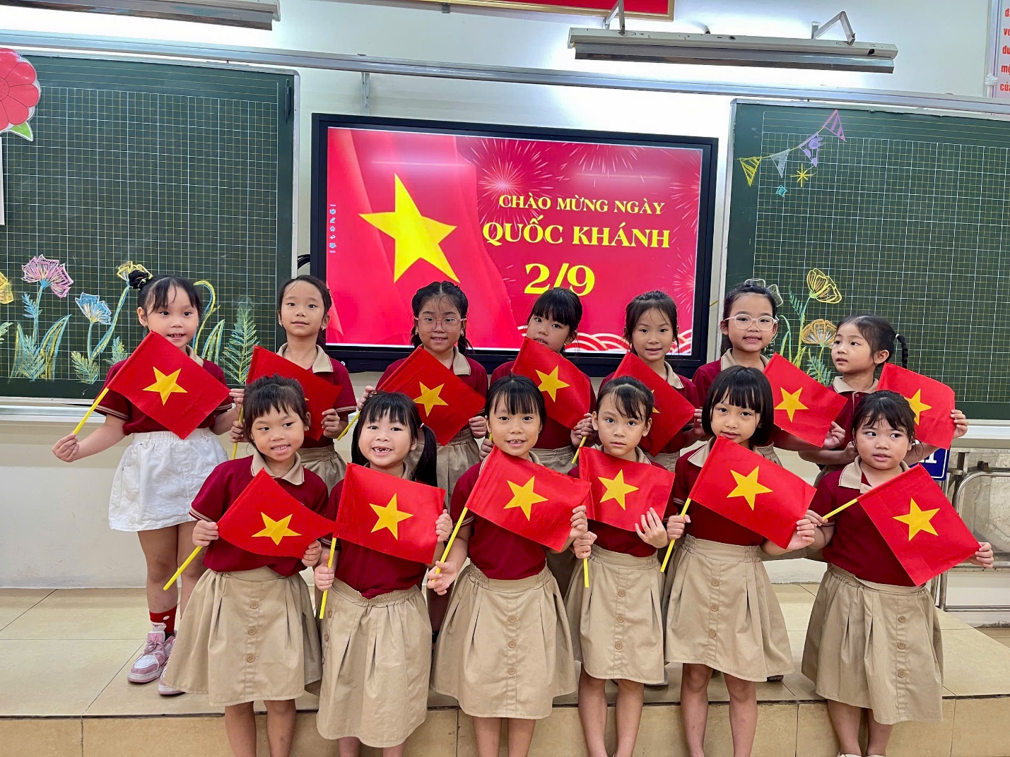 A group of children holding flags

AI-generated content may be incorrect.