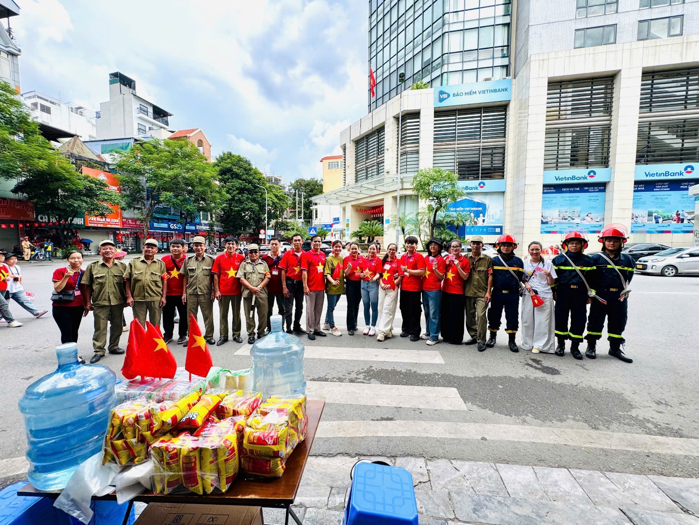 A group of people standing in front of a table with food
AI-generated content may be incorrect.