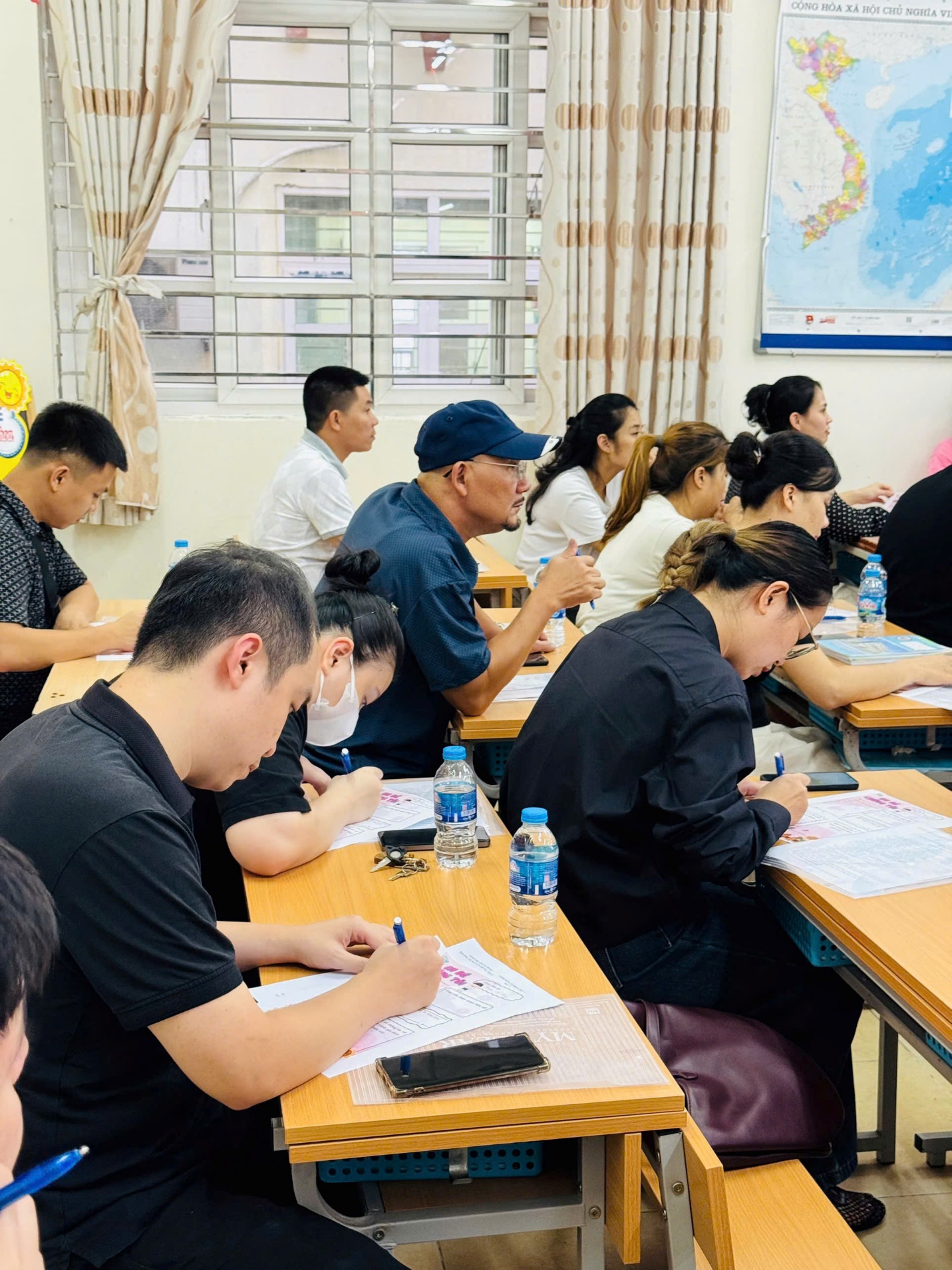 A group of people sitting at desks in a classroom

AI-generated content may be incorrect.