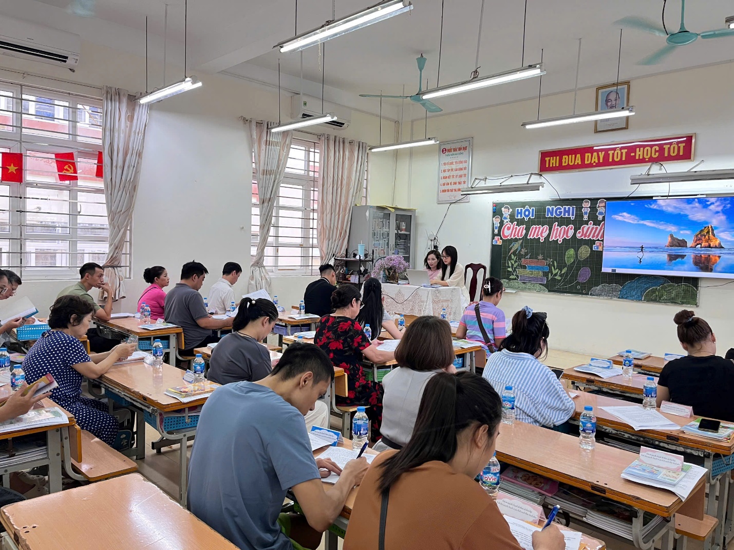 A group of people sitting at desks in a classroom

AI-generated content may be incorrect.