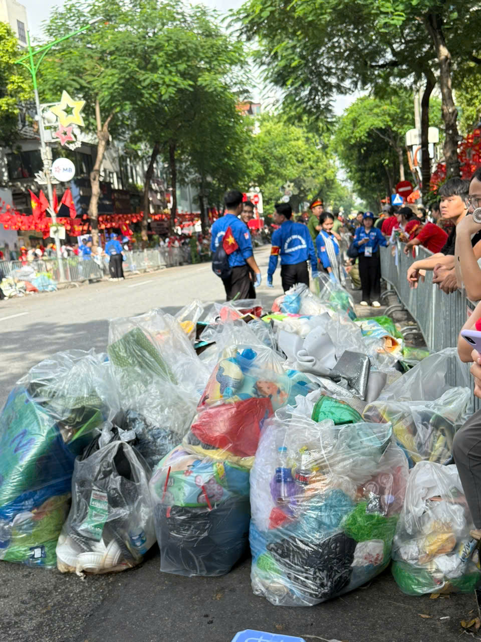 A group of people in blue shirts and blue shirts standing on a street

AI-generated content may be incorrect.