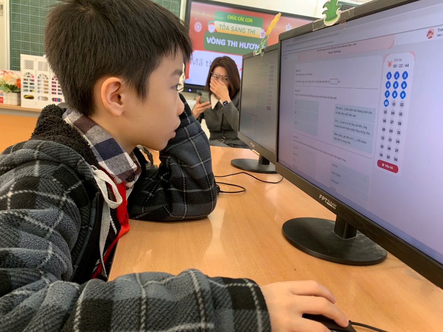 A child sitting at a desk with two computer screens

AI-generated content may be incorrect.