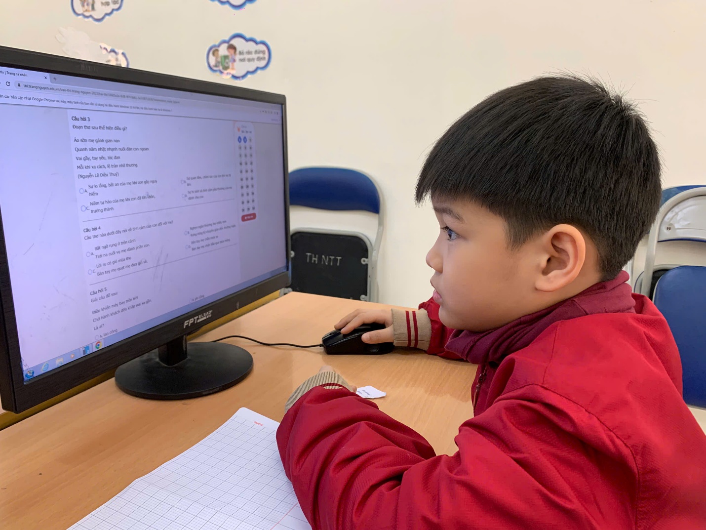 A child sitting at a desk using a computer

AI-generated content may be incorrect.