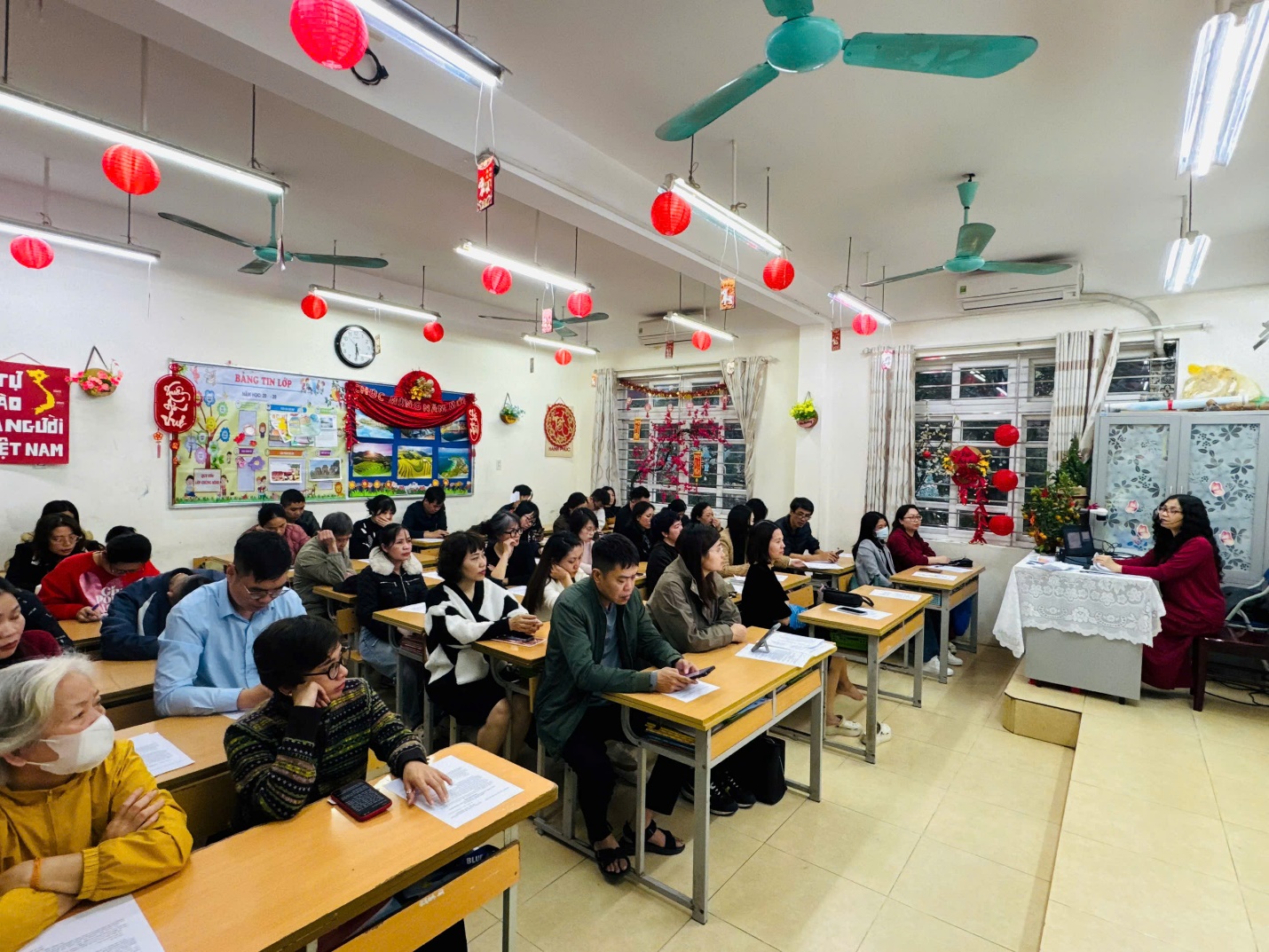 A group of people sitting at desks in a classroom

AI-generated content may be incorrect.