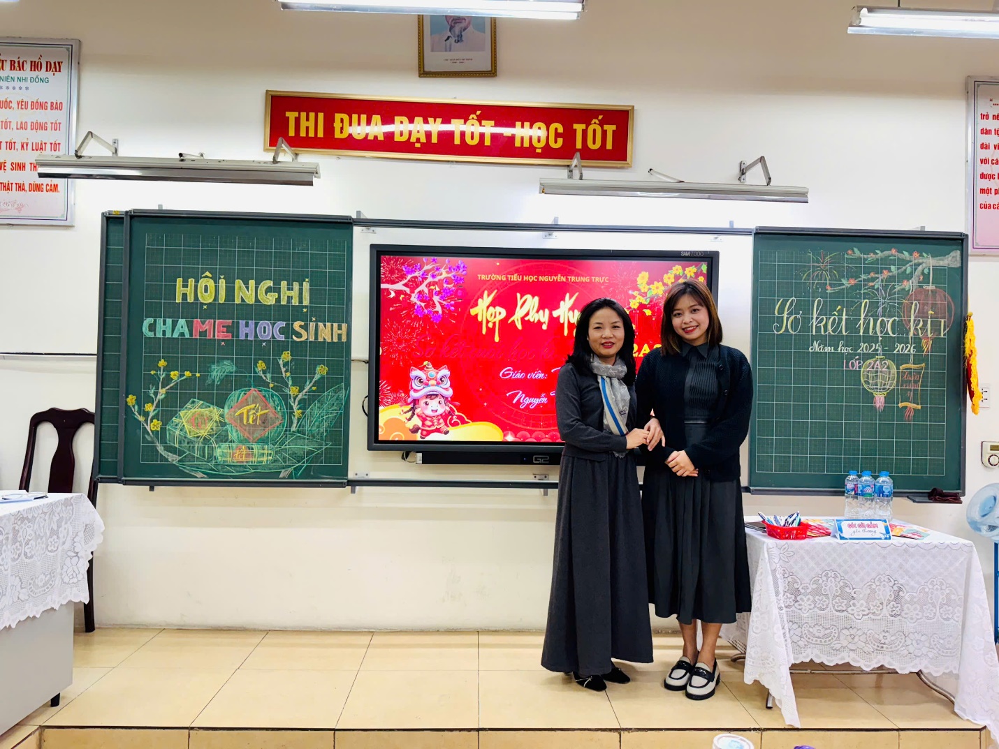 Two women standing in front of a chalkboard

AI-generated content may be incorrect.