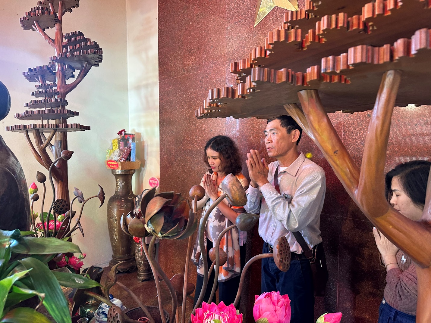 A person and person praying in front of a tree

AI-generated content may be incorrect.