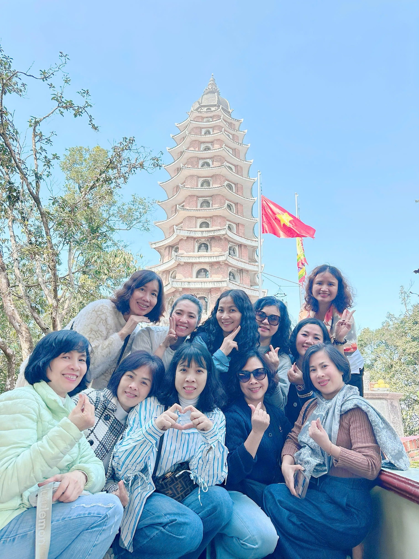 A group of women posing for a picture

AI-generated content may be incorrect.