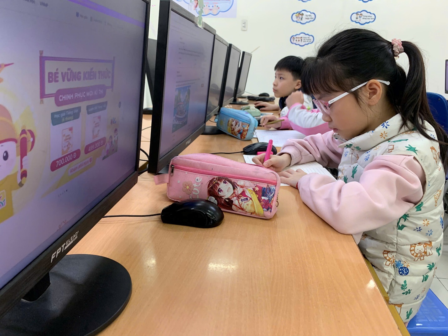 A child sitting at a desk with a computer

AI-generated content may be incorrect.
