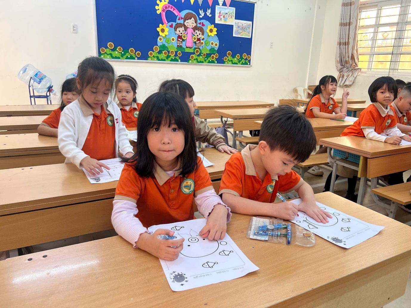 A group of children sitting at desks in a classroom

AI-generated content may be incorrect.