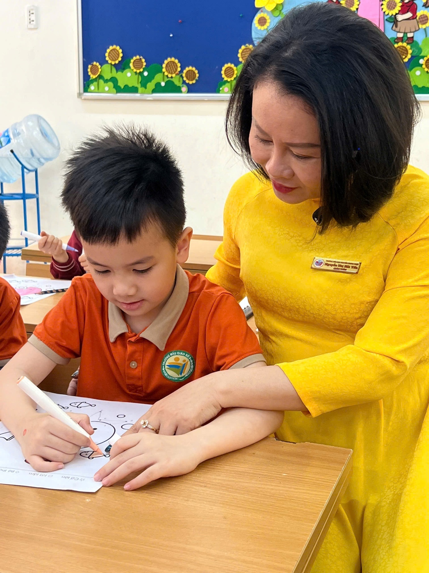 A person helping a child with writing

AI-generated content may be incorrect.