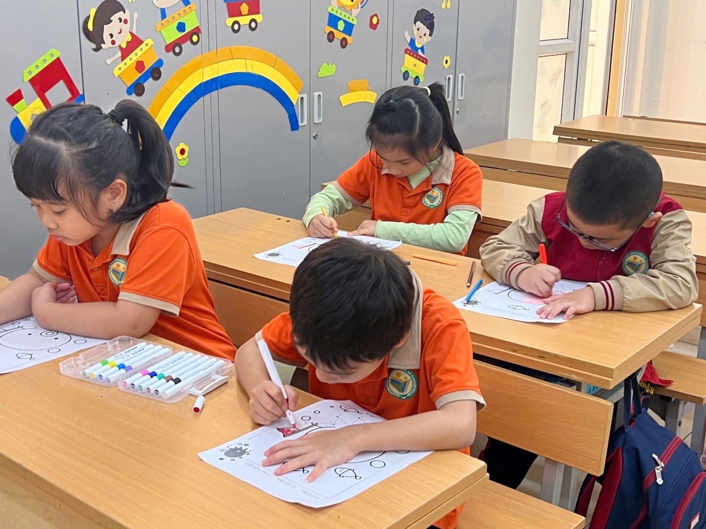 A group of children sitting at desks in a classroom

AI-generated content may be incorrect.