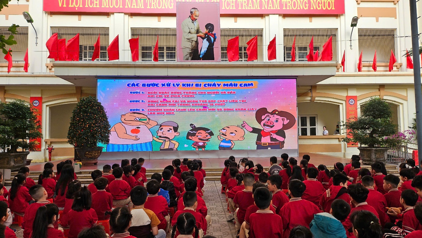 A group of people in red shirts sitting on the floor

AI-generated content may be incorrect.