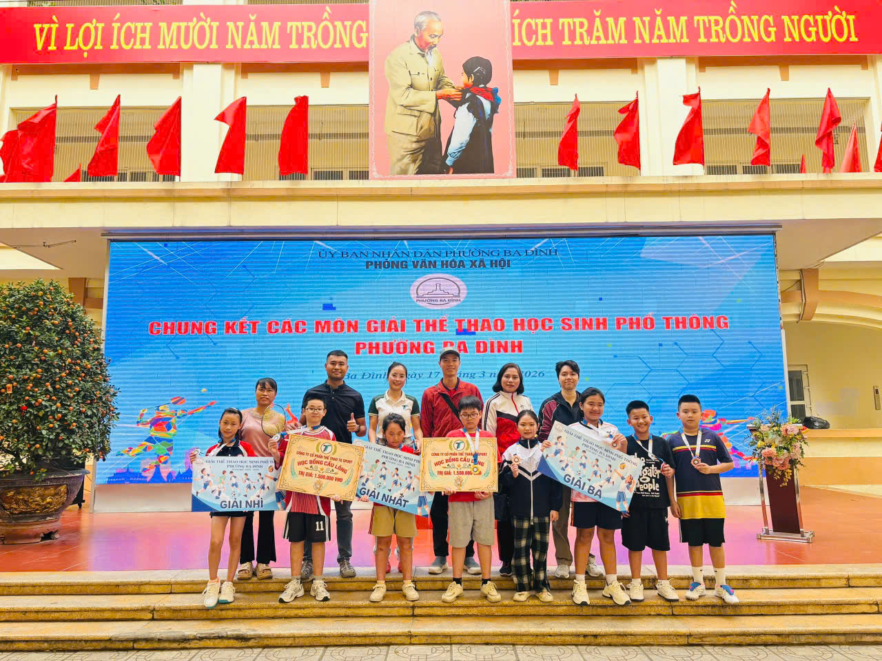 A group of people standing on steps holding signs
AI-generated content may be incorrect.