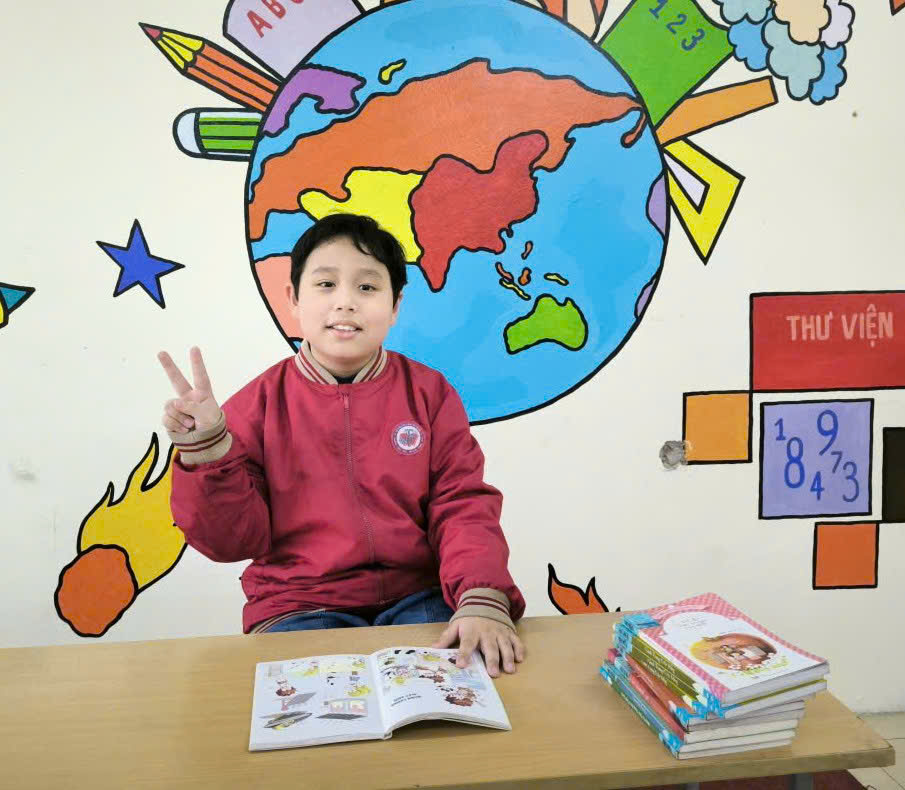 A child sitting at a desk with a book and a peace sign
AI-generated content may be incorrect.